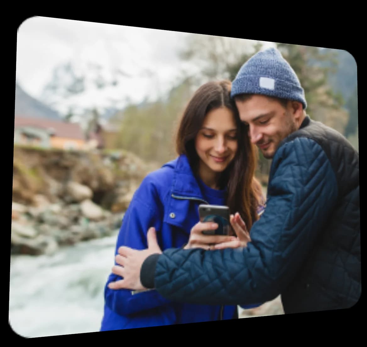 Tourists checking a phone by a river